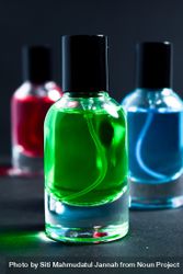 Green, blue and red glass bottles in dark studio 5pgOle