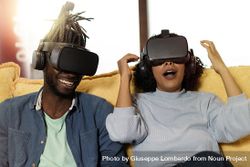 Two people on couch using VR googles 5lVmOe