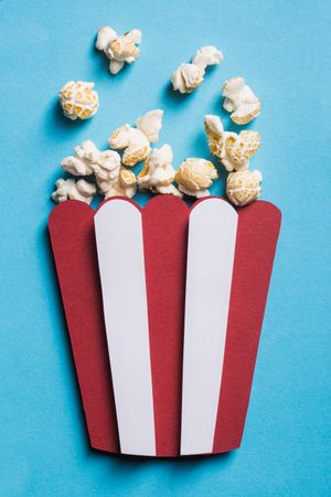 Silhouette of a popcorn box made of cardboard with real popcorn