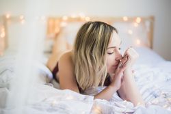 Woman lying in bed at home