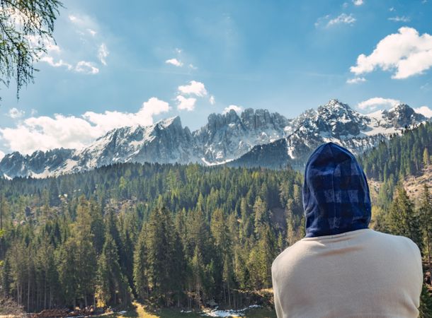 Woman covering head from sun and looking at amazing landscape