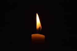 Side view of candle burning in the dark