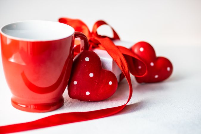 Red mug and heart decorations for St. Valentine's day card