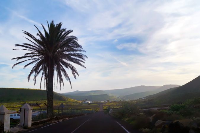 Endless road riding to mountains along fields