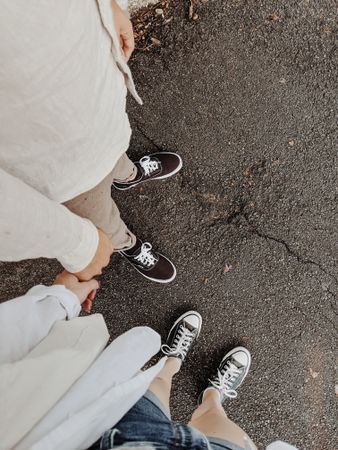 Cropped image of couple holding hands from top view