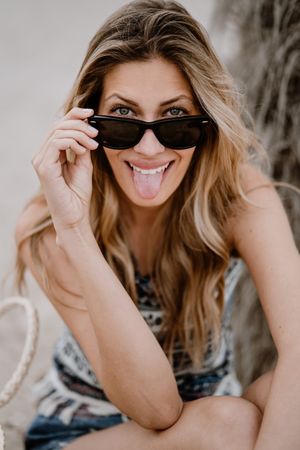Portrait of young cheerful woman with sunglasses
