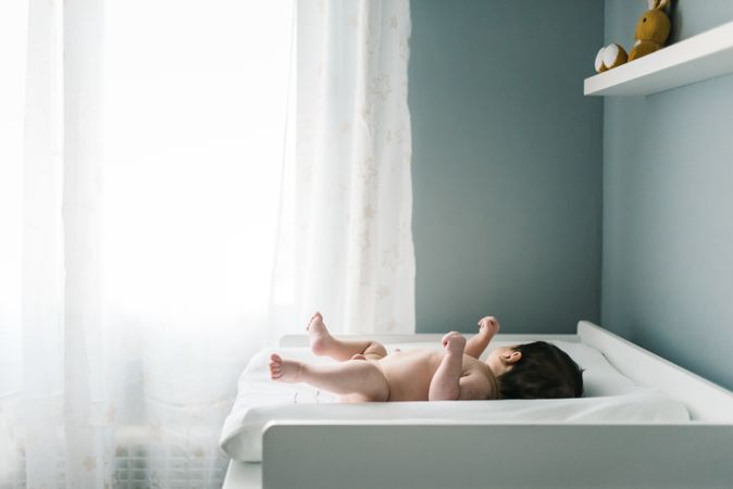 newborn baby boy lying down naked