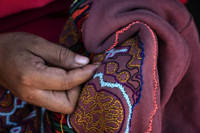 Hands making embroidery