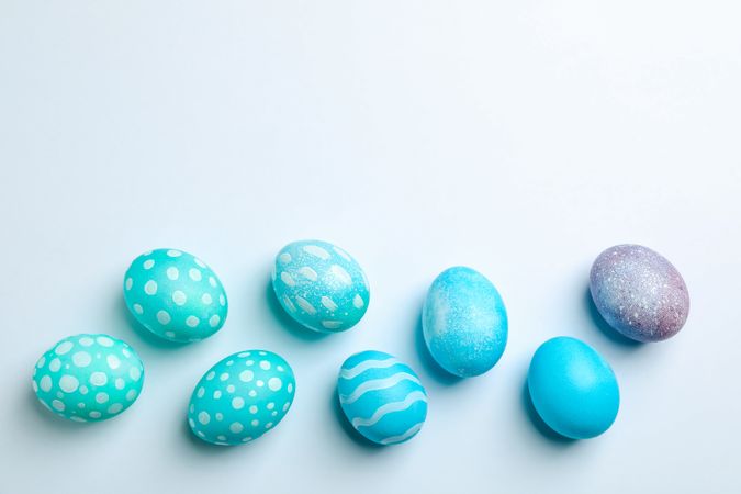 Flat lay composition with Easter eggs on neutral background, space for text