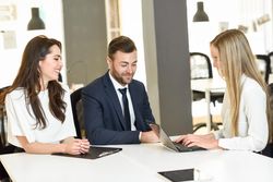 Three colleagues working together in modern office