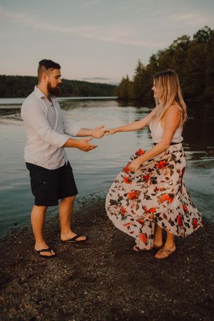 Loving couple standing ankle deep in water on beach
