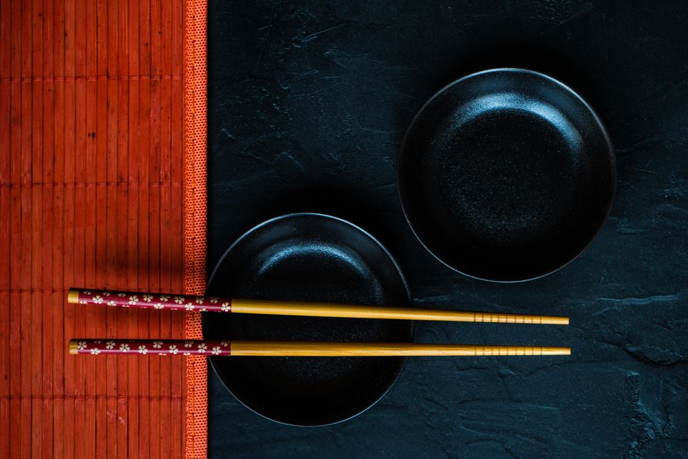 Table setting with chopsticks and two small bowls and copy space