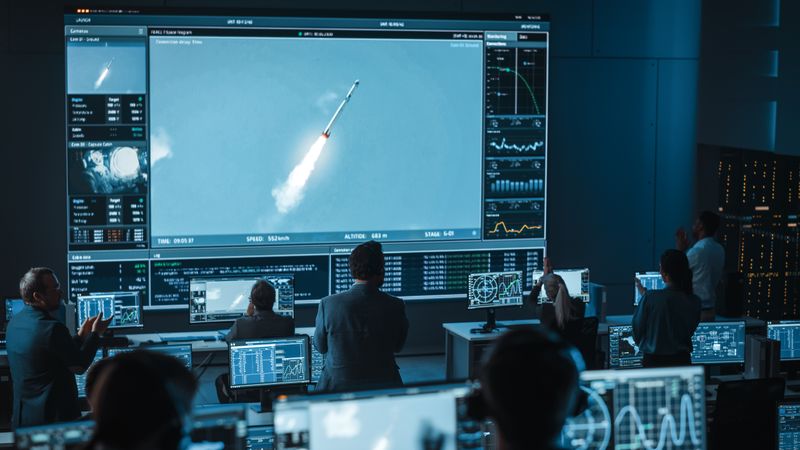 Rocket Launch Monitored in High-tech Control Room. Team Tracks Flight Data on Multiple Screens.