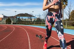 Slim woman running on stadium