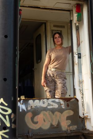 Female soldier in military vehicle