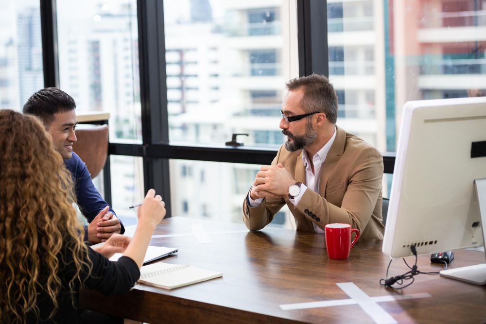 Business man discussing with team colleagues in co-working space or office meeting room