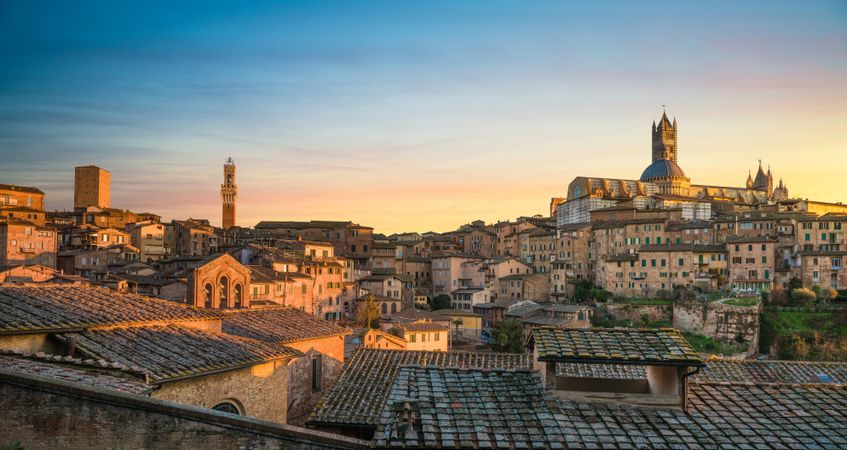 Siena sunset panoramic skyline with Mangia tower and cathedral duomo,Tuscany
