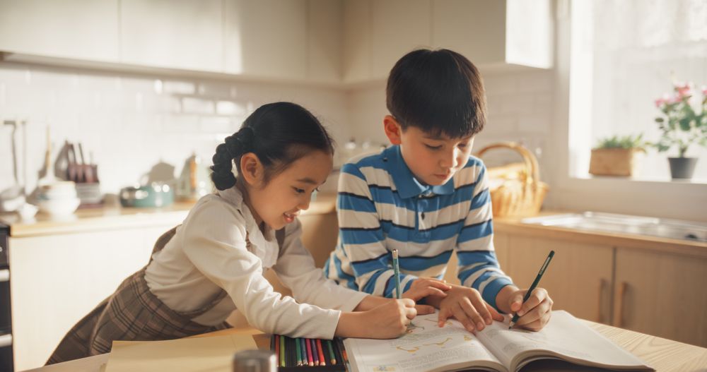 Kids in the Kitchen at Home: Cute Korean Children Are Coloring and Doing Homework While Waiting for Breakfast.