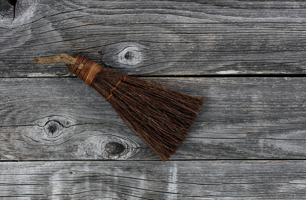 Vintage handbroom on old wooden floor