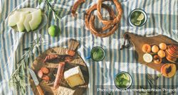 Summer picnic spread with pretzels, fruits, mojitos, meat and cheese board 0yjW15