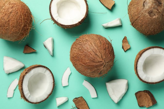 Flat lay with coconut on mint background, top view