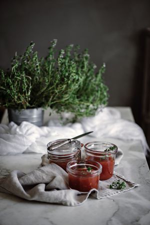 Cans with tomatoes jam on napkin