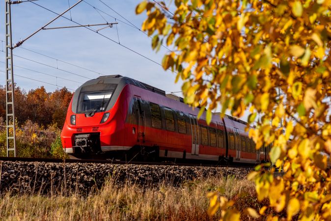 Commuter train traveling through  an autumn scenery in Nuremberg