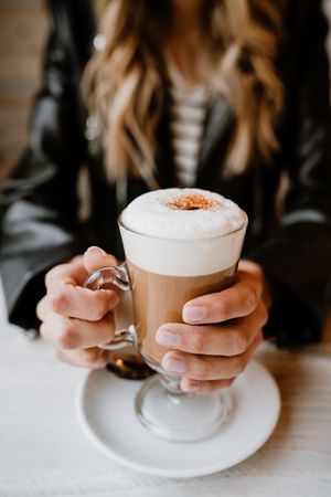 Woman drinking coffee from a glass