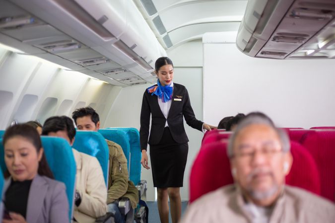 Flight attendant doing final security check before take off