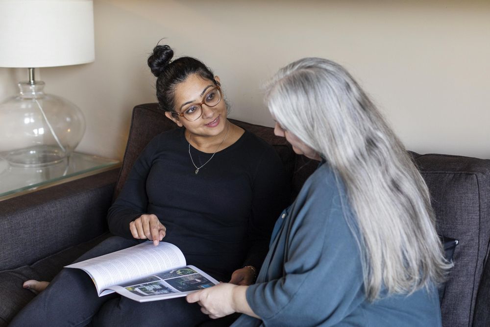 Two women looking at a magazine together
