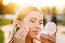 Female fixes makeup on street