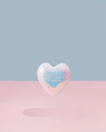Iridescent sequins heart on and pink background