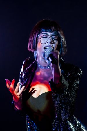 Stylish woman singing on stage