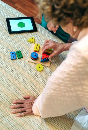 Female doctor showing shapes to older patient