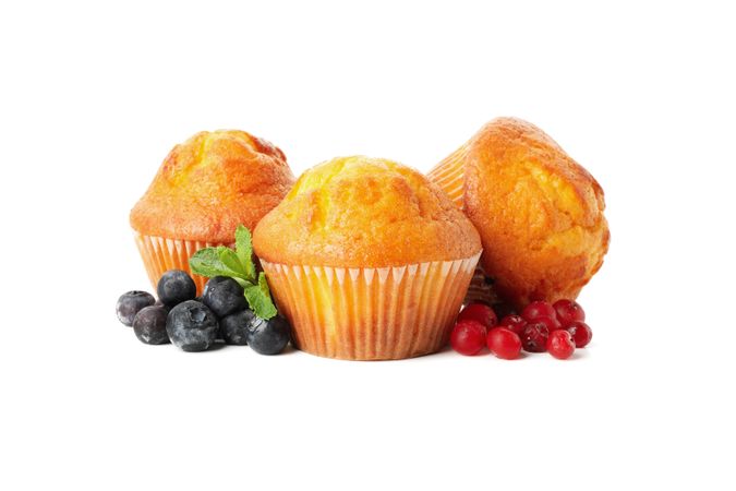 Muffins, berries and chocolate isolated on studio background