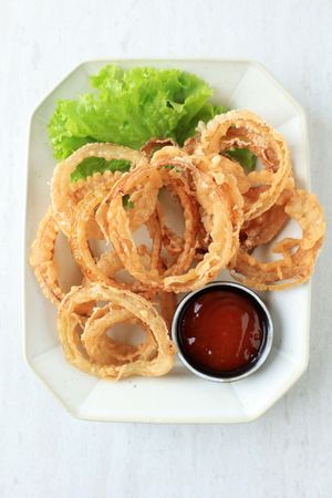 Homemade Breaded Onion Rings with Ketchup on a Plate