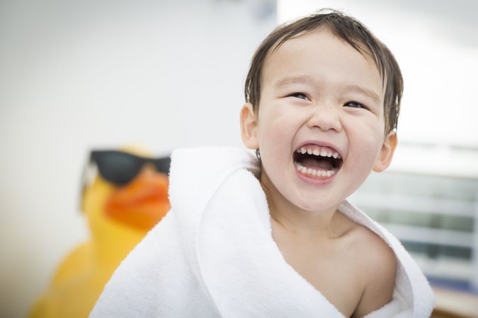 Smiling Boy Wrapping In Towel at the Water Park