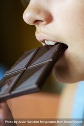 Anonymous girl biting yummy chocolate bar at home 5RVEv1