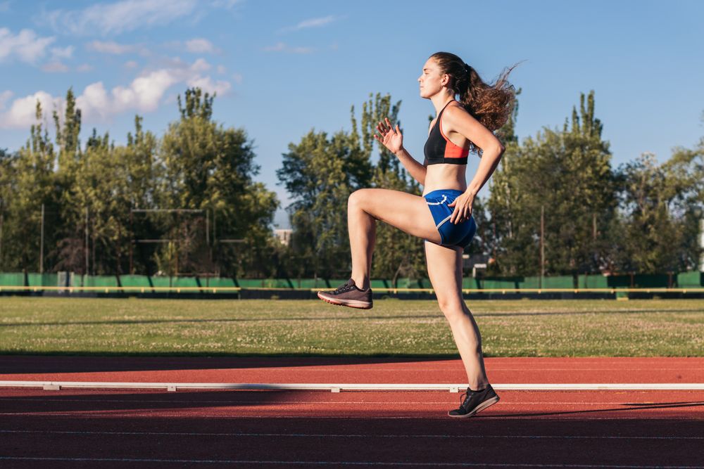 A female athlete warming up before running.