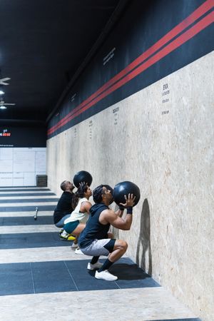 Hispanic sportspeople training with medical balls