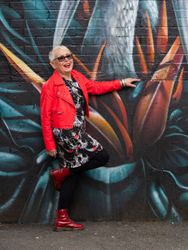 Grey haired woman in red leather jacket