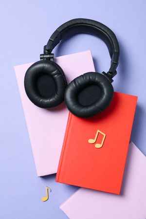 Concept of audiobook with books and headphones, top view