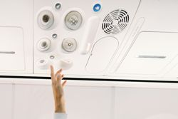 Person pressing button on panel up airplane