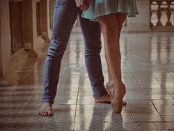 Crop ballerina with male dancer on tiled floor