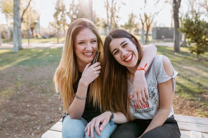 Woman hugging and laughing in park