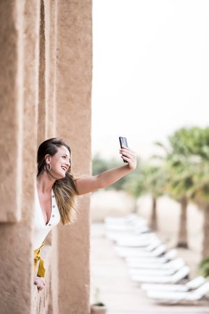Woman making a selfie in balcony