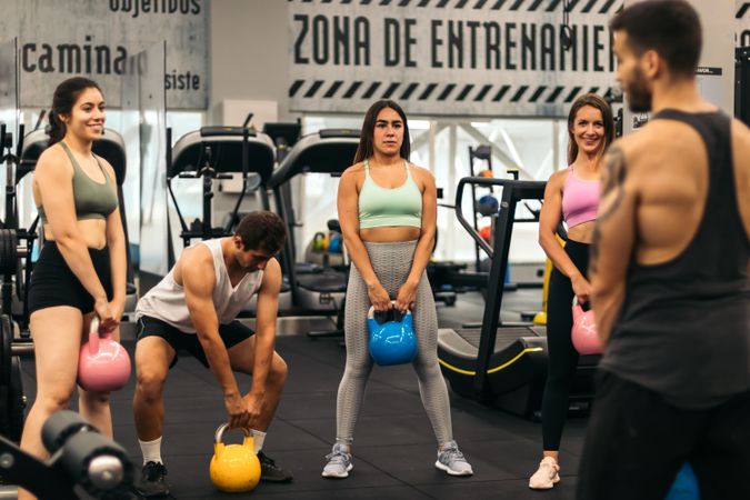 fitness class lifting kettlebells in a gym