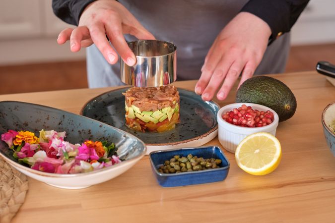 Cook preparing tartar in kitchen