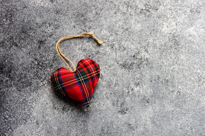 Tartan felt heart ornament on grey counter