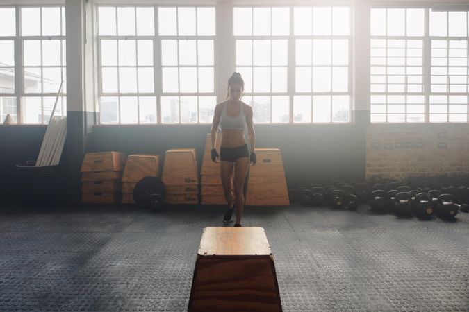 Image of fit young woman at crossfit gym with a jump box exercise equipment